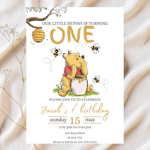 May include: A birthday invitation with a Winnie the Pooh illustration, bees, and a honey pot. The text says "Our Little Hunny is Turning One" and invites guests to celebrate Jacob's 1st birthday on May 15th. Includes RSVP details.