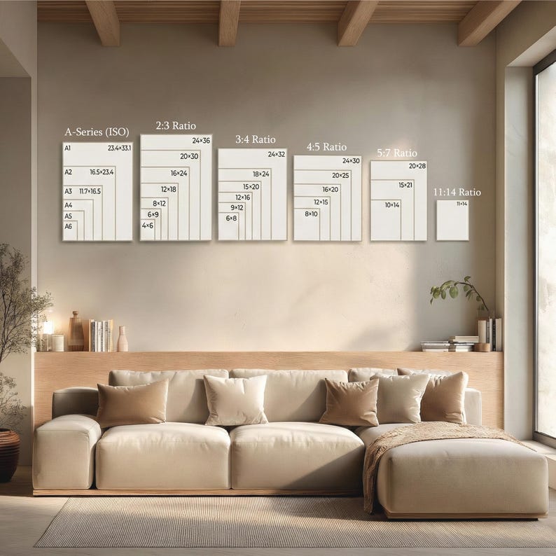 May include: A beige sectional sofa with several throw pillows and a blanket. Above the sofa, there are framed size ratio charts, including A-Series (ISO), 2:3, 3:4, 4:5, 5:7, and 11:14 ratios, with measurements in inches.