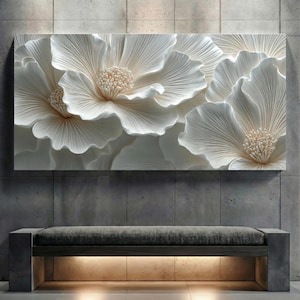 May include: A large, rectangular wall art piece featuring a close-up of white, textured flowers with detailed petals and beige centers. The artwork is mounted on a gray concrete wall above a bench with a gray cushion and a wooden frame.