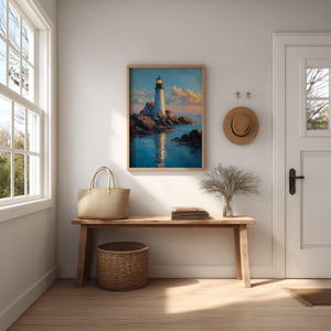 May include: A framed painting of a lighthouse on a rocky coast, reflecting in the water. The artwork is displayed above a wooden bench with a woven basket, a tote bag, and a stack of books. A straw hat hangs on the wall.