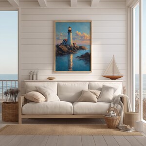 May include: A framed painting of a lighthouse on a rocky coast, reflecting in the water. The artwork features a white lighthouse with a lit beacon, set against a blue sky with clouds. The scene is displayed above a white sofa.