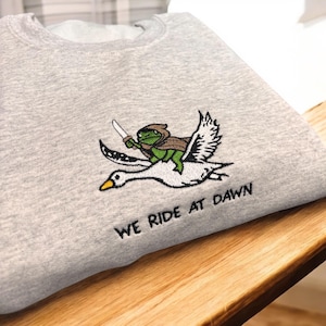 Frog Riding Swan “ we ride at dawn” Embroidered Sweatshirt.