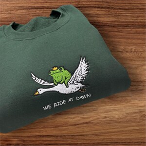 Frog Riding Swan “ we ride at dawn” Embroidered Sweatshirt.