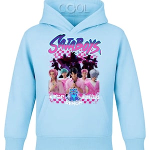 May include: Light blue hoodie with a graphic featuring the text "SataBoys" in pink and purple, along with an image of a group of people. The graphic also includes the words "Pop Demon Hunters".
