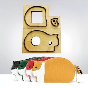 May include: A set of guinea pig-shaped leather pouches in various colors, including black, green, red, white, and orange. Above, a wooden die-cut mold with corresponding shapes is visible.