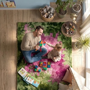 May include: An overhead shot of a family playing with colorful magnetic tiles on a green and pink rug. A man and a child are building with the tiles. Children's books and a small teepee are also visible.