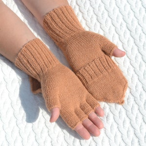 Light bown alpaca half finger convertible gloves with mitten flaps on model's hands