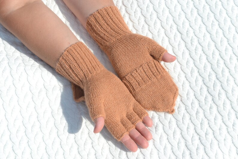 Light bown alpaca half finger convertible gloves with mitten flaps on model's hands