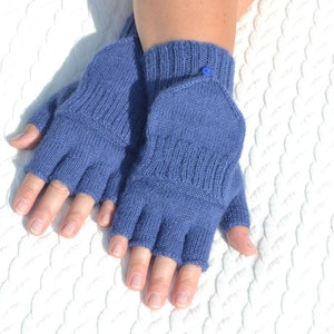 Hand knitted blue alpaca half finger mittens on model's hands