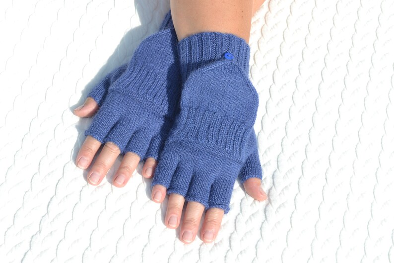 Hand knitted blue alpaca half finger mittens on model's hands