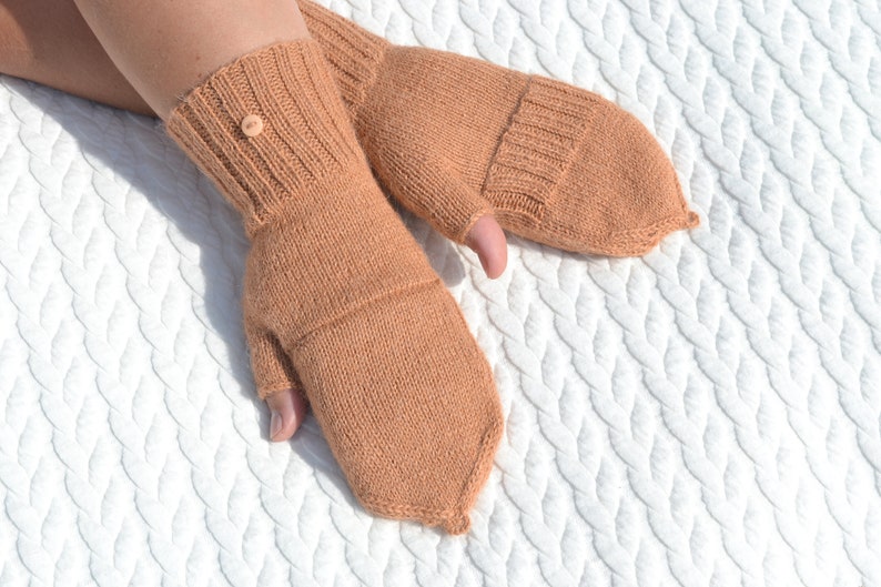 Light bown alpaca half finger convertible gloves with mitten flaps on model's hands