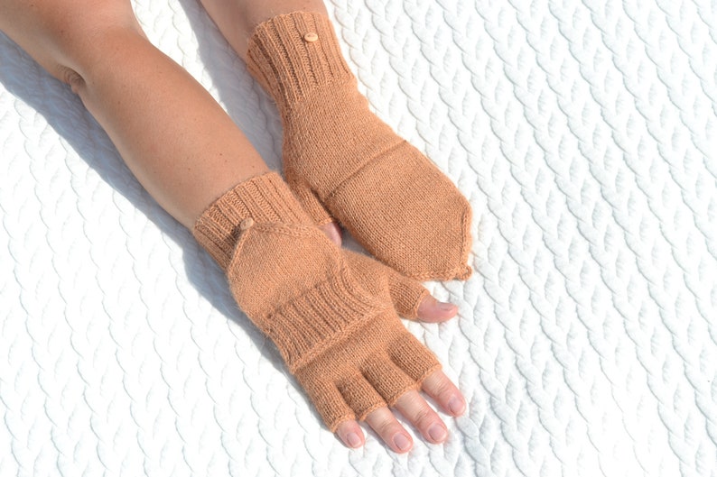 Light bown alpaca half finger convertible gloves with mitten flaps on model's hands