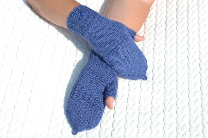 Hand knitted blue alpaca half finger mittens on model's hands