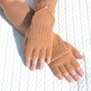 Light bown alpaca half finger convertible gloves with mitten flaps on model's hands