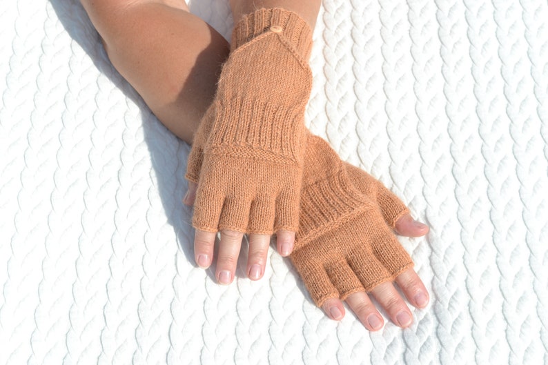 Light bown alpaca half finger convertible gloves with mitten flaps on model's hands