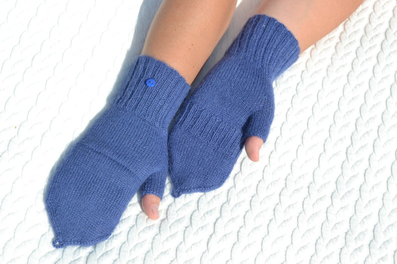 Hand knitted blue alpaca half finger mittens on model's hands