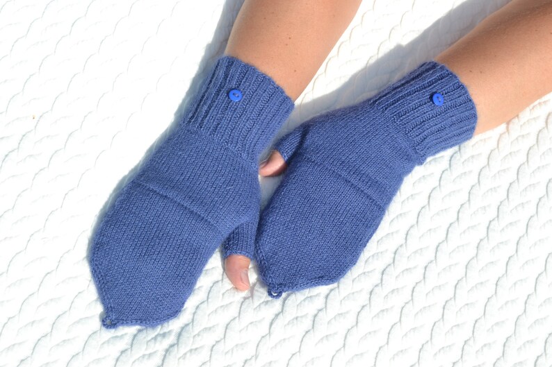 Hand knitted blue alpaca half finger mittens on model's hands