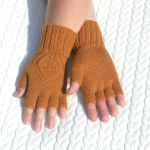 Handmade ocher alpaca half finger gloves on model's hands