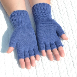 Hand knitted blue alpaca half finger mittens on model's hands