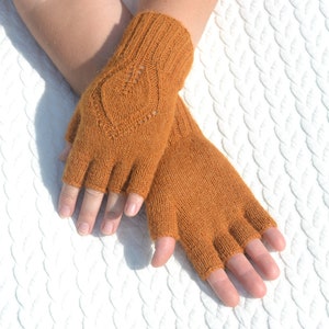 Handmade ocher alpaca half finger gloves on model's hands