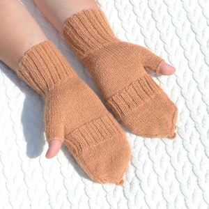 Light bown alpaca half finger convertible gloves with mitten flaps on model's hands