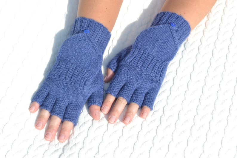 Hand knitted blue alpaca half finger mittens on model's hands