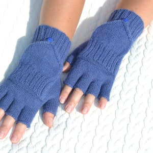 Hand knitted blue alpaca half finger mittens on model's hands