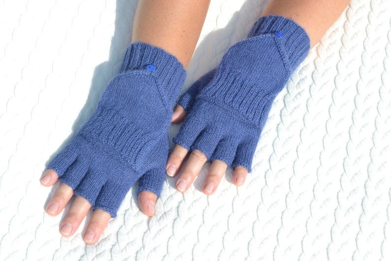 Hand knitted blue alpaca half finger mittens on model's hands