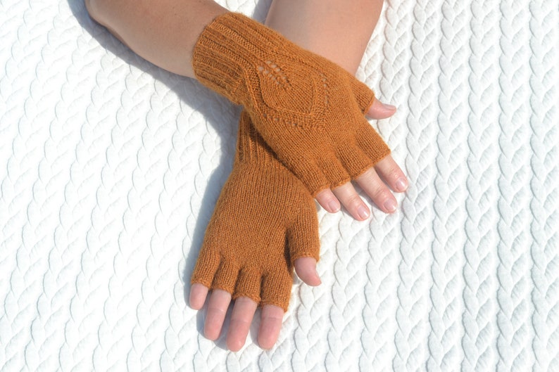 Handmade ocher alpaca half finger gloves on model's hands