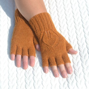 Handmade ocher alpaca half finger gloves on model's hands