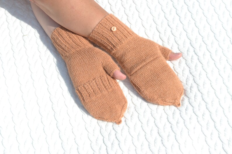 Light bown alpaca half finger convertible gloves with mitten flaps on model's hands