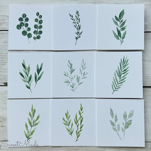 May include: Nine watercolor paintings of different green leafy branches on white card stock.