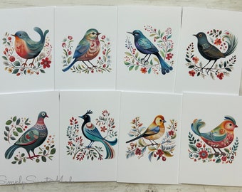 May include: Set of eight illustrated greeting cards featuring colorful birds with floral designs. Each card features a different bird species with intricate details and vibrant colors.