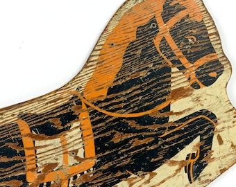 May include: A vintage wooden rocking horse cutout with a distressed finish. The horse is painted black with orange mane, bridle, and saddle details. The wood grain is visible, adding to the antique aesthetic. A classic toy for children.