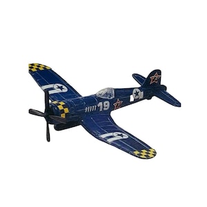 May include: A dark blue toy airplane with white star and circle decals, and yellow and black checkered accents on the wings and tail. The number "19" is visible on the side of the plane. The propeller is black.