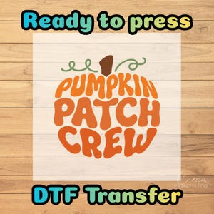 May include: A DTF transfer featuring an orange pumpkin graphic with a brown stem and green vines. The text PUMPKIN PATCH CREW is written in a bold, wavy orange font inside the pumpkin shape. The words Ready to press appear above and DTF Transfer below.