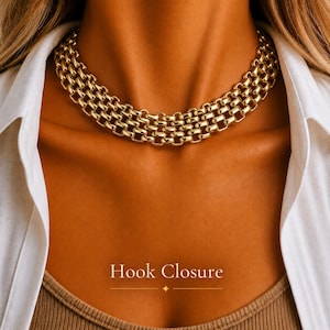 May include: A gold-toned choker necklace featuring a multi-row chain design with interlocking rounded links. The necklace sits closely around the neck and includes the text Hook Closure printed in white at the bottom of the image.