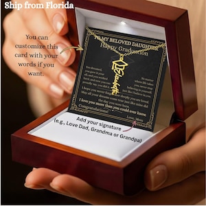May include: A graduation gift set in a wooden box. The box contains a gold-colored necklace with a graduation cap pendant and the name "Elizabeth" in cursive. A personalized card is also included, with text that reads "To My Beloved Daughter, Happy Graduation."