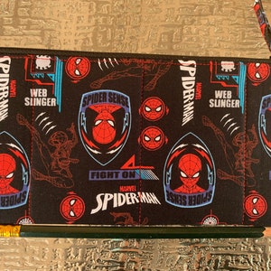 May include: Black zippered pouch with a repeating pattern of Spider-Man characters, logos, and the words "Spider-Sense", "Web Slinger", and "Fight On".