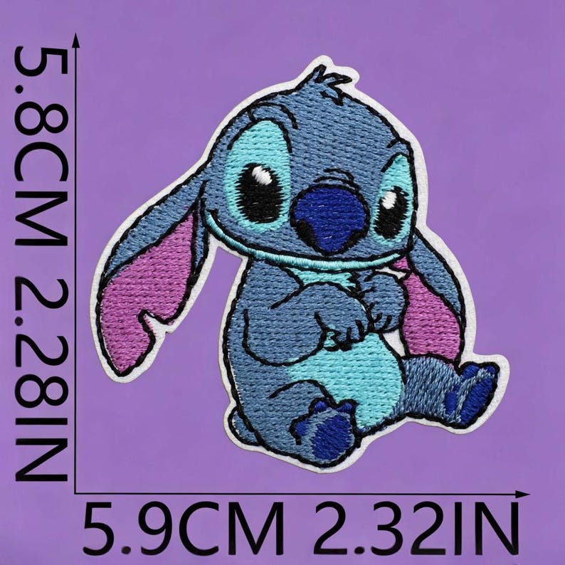 May include: An embroidered patch of a blue alien character with large ears, a dark blue nose, and a light blue chest. The patch measures 5.8 cm by 5.9 cm, or 2.28 inches by 2.32 inches, and features pink inner ears and black eyes.