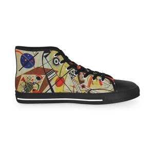 May include: High-top canvas trainers with a black toe cap and sole. The upper features an abstract design with geometric shapes, lines, and circles in various colours, including blue, red, yellow, and brown. The laces are black.