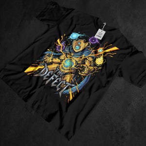 May include: Black t-shirt featuring a gold and blue graphic of a character with energy effects and the text "THE DEFECT". The design includes a figure with a helmet and cape, surrounded by lightning and orbs. A tag indicates the size is large.
