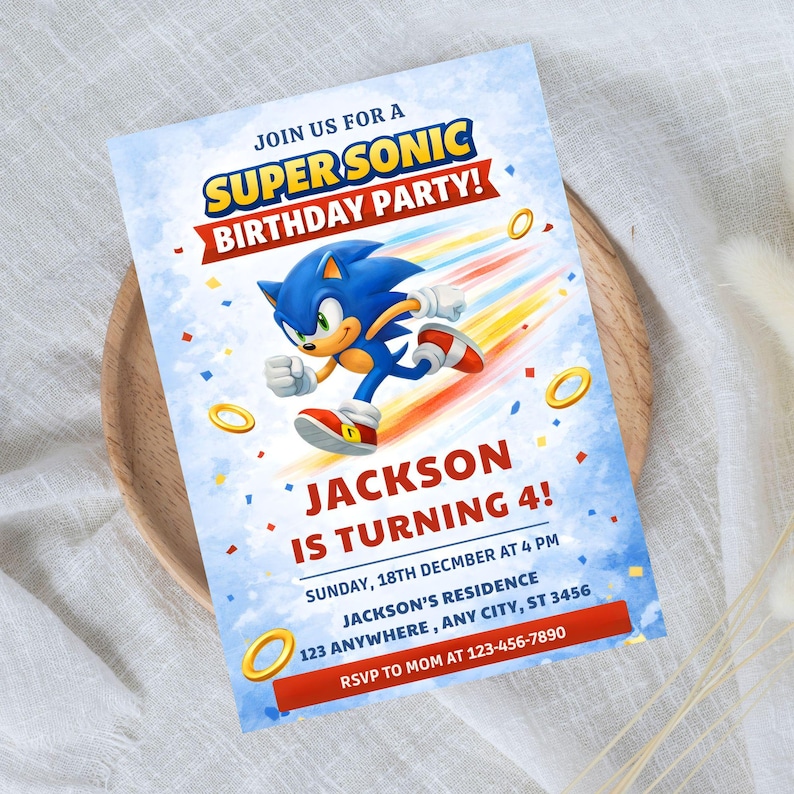 May include: A blue and white birthday party invitation featuring Sonic the Hedgehog. The invitation includes the text "SUPER SONIC BIRTHDAY PARTY!" and "JACKSON IS TURNING 4!" with event details.