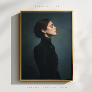 May include: A framed fine art print featuring a portrait of a woman in profile. The woman is wearing a black high-collared jacket with gold buttons. The print has a gold frame and the text "DELARÉ ATELIER" and "UNFRAMED FINE ART PRINT".