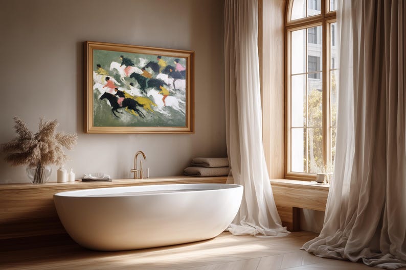 May include: A modern bathroom with a white oval bathtub, a framed painting of horses, and a large window with sheer curtains. The painting features riders on horses in motion. The room has a neutral color palette with wood accents.