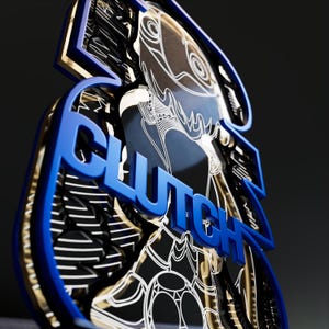 May include: A layered, abstract design with the word "CLUTCH" in bold, blue letters. The design features intricate patterns and a combination of black, white, and gold accents, creating a modern, artistic aesthetic.