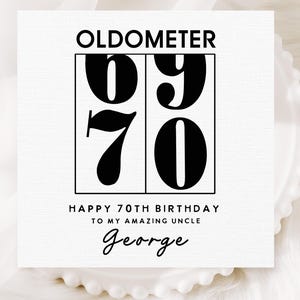 May include: A white card with the word "OLDOMETER" at the top. Below, the numbers "69" and "70" are displayed in a black, bold font. The text "HAPPY 70TH BIRTHDAY TO MY AMAZING UNCLE George" is written in black.