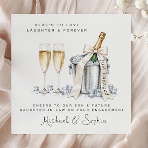 May include: A square greeting card featuring an illustration of two champagne flutes and a bottle in an ice bucket. The ribbon on the bottle reads Just Engaged. Text reads Here's to love laughter & forever, Cheers to our son & future daughter-in-law on your engagement, and Michael & Sophia.