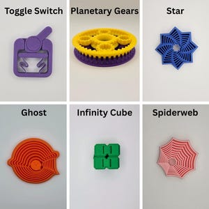 May include: A selection of 3D-printed toys. The image shows a purple toggle switch, a yellow and purple planetary gear, and a blue star. Other items include a ghost, infinity cube, spiderweb, gear clicker, tornado, and air spinner.