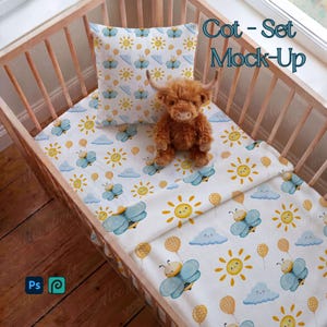 May include: A cot set mock-up featuring a white sheet and pillow with a repeating pattern of blue bees, yellow suns, and clouds. A stuffed brown Highland cow sits on the bedding. The cot is made of light-colored wood.